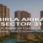 Modern residential towers of Birla Arika Sector 31 Gurgaon with clubhouse and pool at sunset